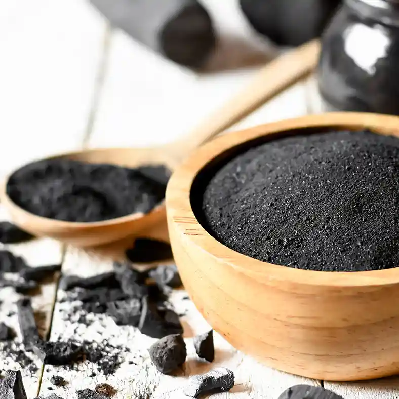 Charcoal powder in wooden bowl