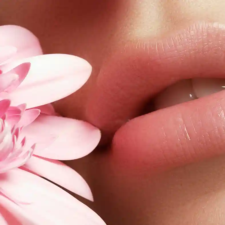 Face with pink lips next to pink flower