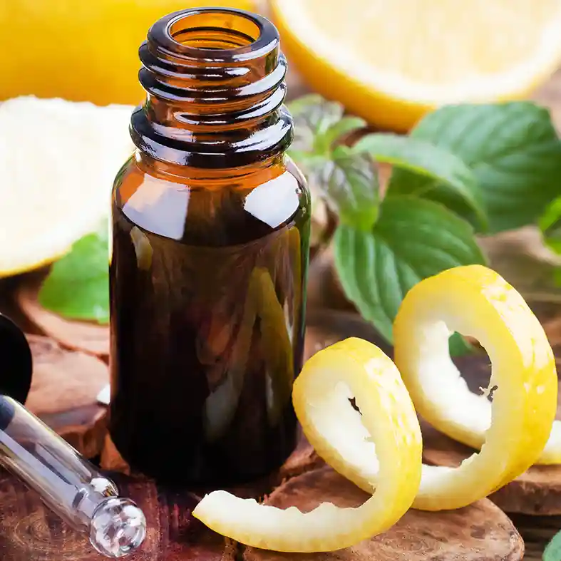 Lemon peels in front of amber glass bottle